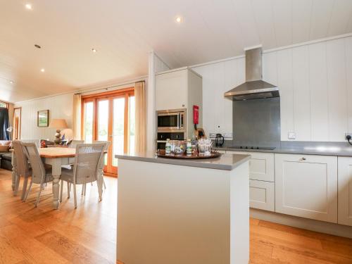 a kitchen and dining room with a table and chairs at Hambleton in Cottesmore