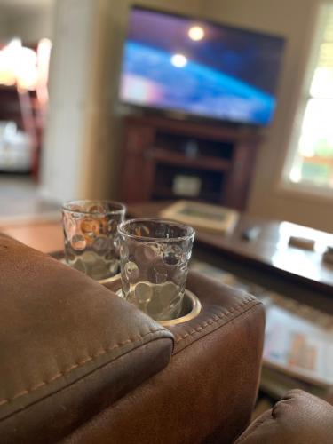 two glasses sitting on top of a table with a purse at Charming Family Lakeview Cottage 3 min to lake in Dandridge