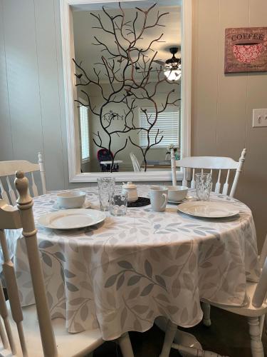 a dining room table with a white table cloth on it at Charming Family Lakeview Cottage 3 min to lake in Dandridge