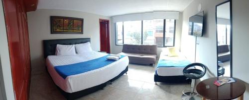 a bedroom with a bed and a couch in it at Hotel AG Boutique in Bogotá