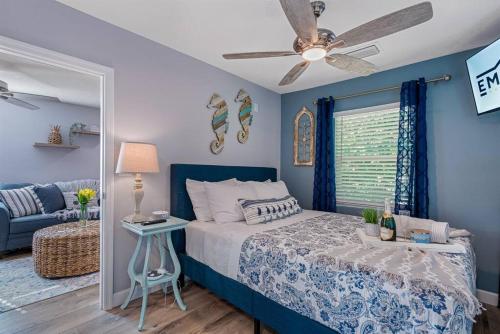 a bedroom with a bed and a blue wall at Downtown Dunedin Gem, Fully Renovated #4 in Dunedin