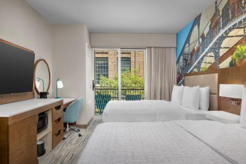 Hampton Inn New Orleans French Quarter Market Area في نيو أورلينز: غرفه فندقيه سريرين وتلفزيون