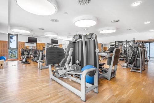 a gym with treadmills and elliptical machines at Palácio Estoril Hotel, Golf & Wellness in Estoril