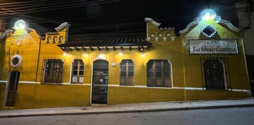 a yellow building with a sign on the side of it at Hotel La Gran Casona in Tunja