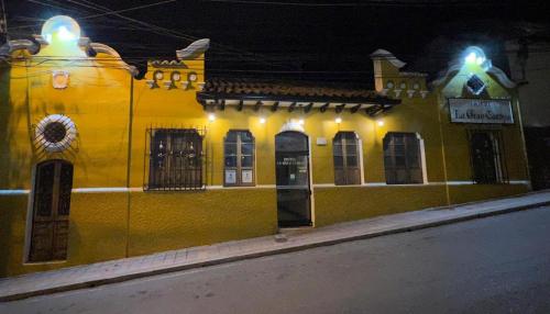 a yellow building with lights on the side of a street at Hotel La Gran Casona in Tunja