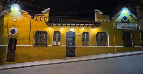 a yellow building with lights on the side of a street at Hotel La Gran Casona in Tunja