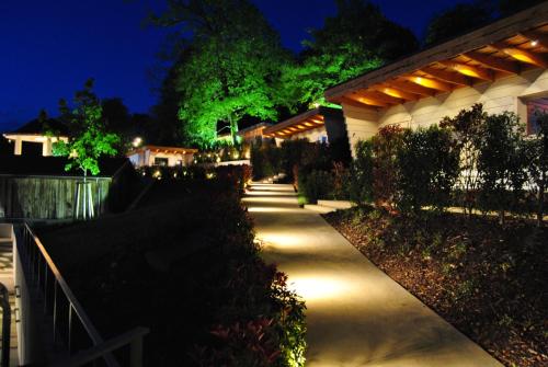 a pathway leading to a house at night at Mondorf Parc Hotel & Spa in Mondorf-les-Bains