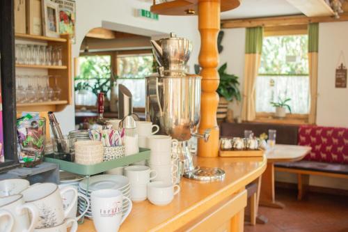 a counter with a bunch of cups on it at Hotel Forsthof in Sankt Johann im Pongau