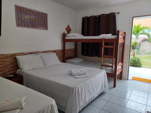 a bedroom with two bunk beds and a ladder at Torre do Sol in Praia do Frances