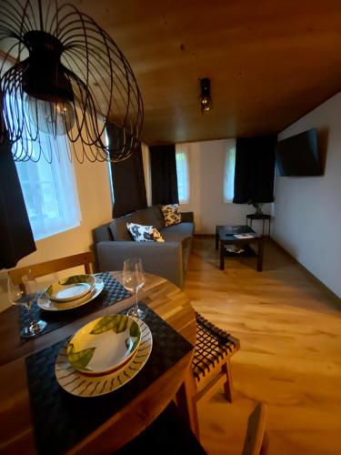 a living room with a table and a couch at Ferienwohnung in Stein AR in Stein
