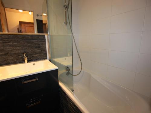 a bathroom with a tub and a sink and a shower at Charmant studio cabine avec WiFi à Avoriaz - FR-1-314-159 in Morzine