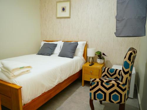 a bedroom with a bed and a chair at Hostal 53 Boutique Santo Domingo in Santo Domingo
