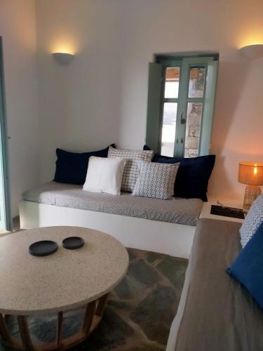 a living room with a couch and a table at Amorgos Elegant Houses, Villa 3 in Aegiali
