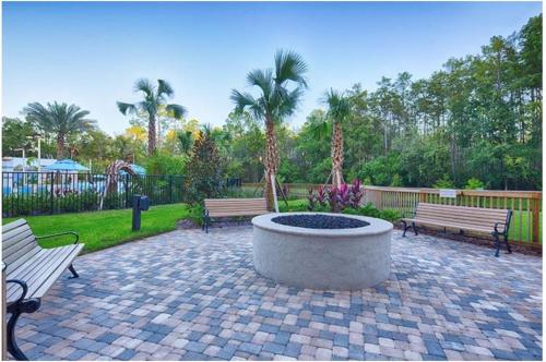 two benches and a fire pit in a park at Vacation Village at Parkway in Orlando