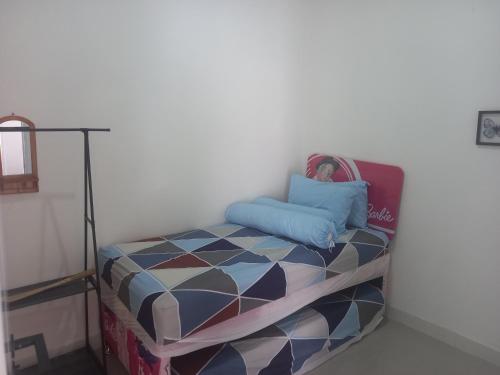 a small ottoman with a pillow on top of it at Villa Akela Sukabumi in Sukabumi