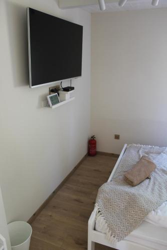 a living room with a tv on the wall at Chechar Inn Zlatar in Nova Varoš