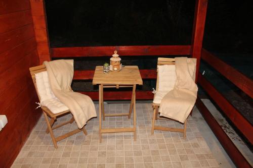 a small table and two chairs in a room at Chechar Inn Zlatar in Nova Varoš