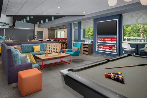 a billiard room with a pool table and furniture at Tru By Hilton Charleston Ashley Phosphate, Sc in Charleston