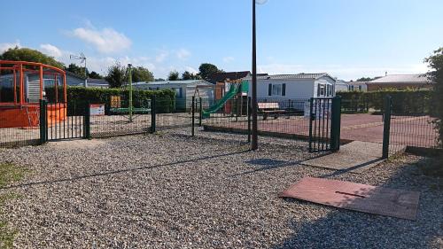 a park with a playground with a swing at n°20 in Biville-sur-Mer