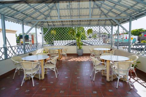 a group of tables and chairs on a patio at Hostal 53 Boutique Santo Domingo in Santo Domingo