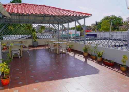 a patio with tables and chairs and a pavilion at Hostal 53 Boutique Santo Domingo in Santo Domingo