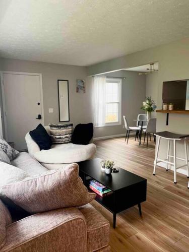 a living room with a couch and a table at New Stylish Condo Monthly Rental in Reminderville