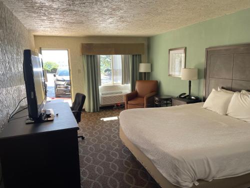 a hotel room with a bed and a television at Quality Inn Clinton North in Clinton
