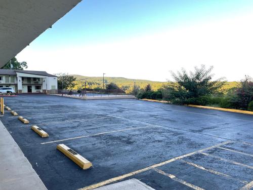 an empty parking lot with yellow barriers in it at Quality Inn Clinton North in Clinton