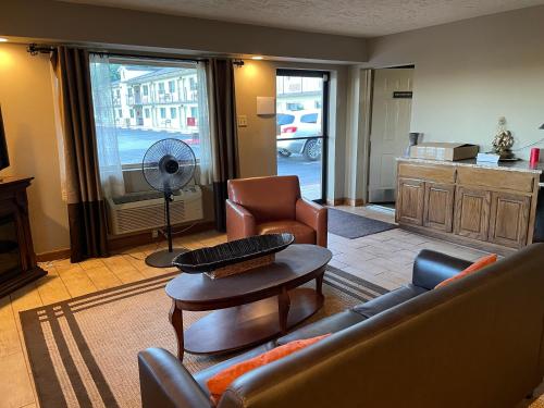 a living room with a couch and a table at Quality Inn Clinton North in Clinton