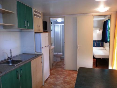ソットマリーナにあるVillaggio Camping Europaのキッチン(シンク付)、トイレが備わります。