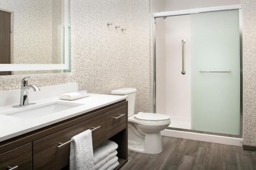 Home2 Suites By Hilton Kenner New Orleans Arpt في كينير: حمام مع حوض ومرحاض ودش