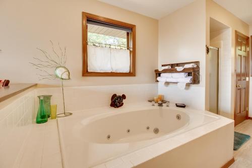 a large white bath tub in a bathroom at Mountain Home Retreat with Balcony and Lake Views! in Mountain Home