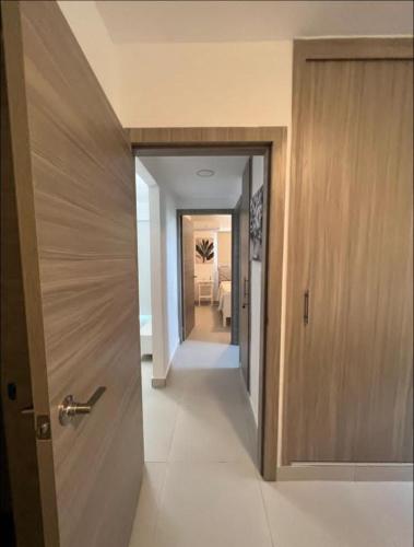 a hallway with a door leading to a room at Sweet home in Punta Cana