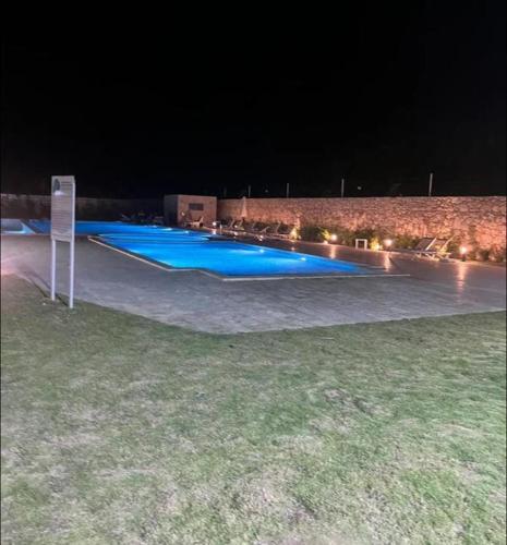 a row of blue swimming pools at night at Sweet home in Punta Cana