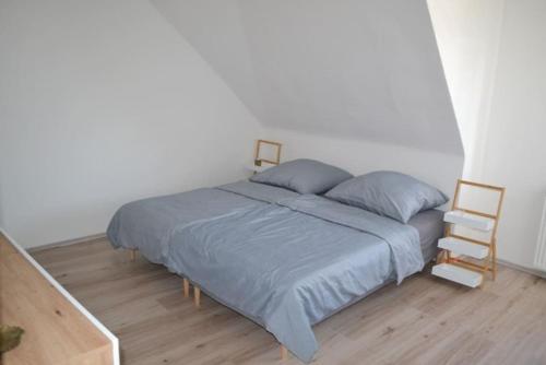 a bedroom with a bed and a wooden floor at Pension,Ferien, Monteurwohnung , Unterkunft,Zimmer in Schönebeck