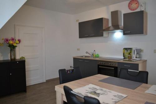 a kitchen with a table and a kitchen with a counter at Pension,Ferien, Monteurwohnung , Unterkunft,Zimmer in Schönebeck