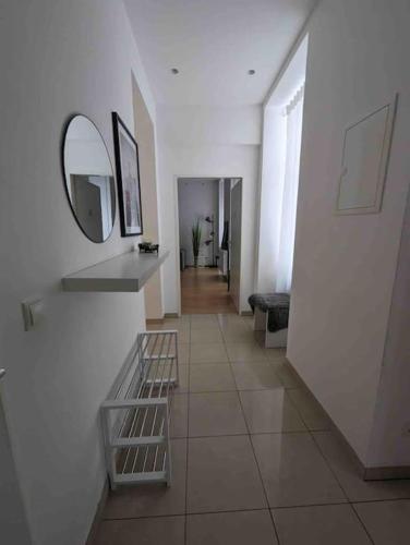 a hallway with a mirror and a tile floor at Luxury CityApartment 7 in Vienna