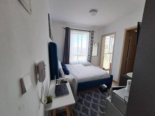 Postel nebo postele na pokoji v ubytování Valentines King Studio, Syokimau