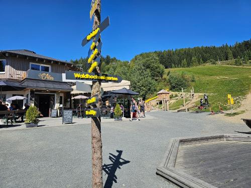 a pole with a yellow and black sign on a street at Gerlitzen-Apartments in Kanzelhöhe