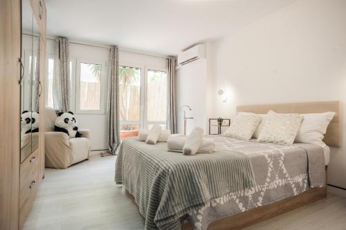 a bedroom with a large bed and a panda bear at Les Arts in Valencia