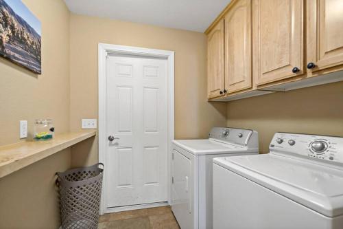 a laundry room with a washing machine and a washer at JoshuaTree N.P. Oasis *Views* Pool/Spa/BBQ in Yucca Valley