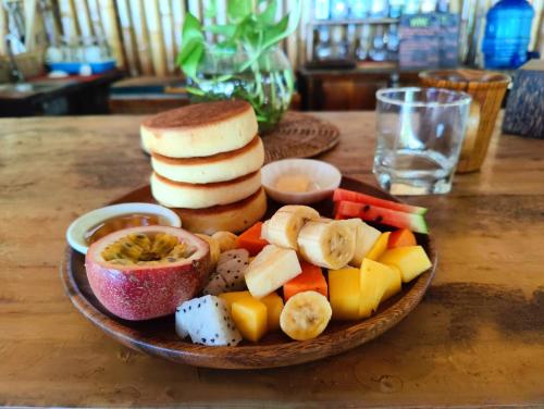 a plate of food with fruit and vegetables on a table at SunBoo Beach Bungalows in Koh Rong Sanloem