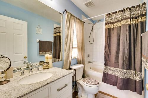 a bathroom with a sink and a toilet and a tub at 2 Mi to Epperson Lagoon Home with Private Yard in Wesley Chapel