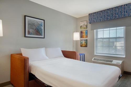 a bedroom with a large white bed and a window at Hampton Inn & Suites Yonkers in Yonkers