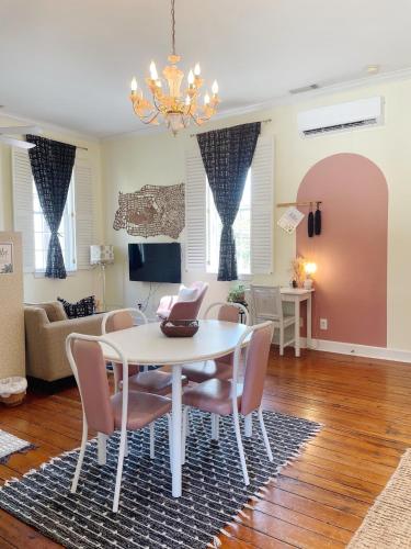 a living room with a white table and chairs at Romantic 1885 Loft Steps from Pulaski Square in Savannah