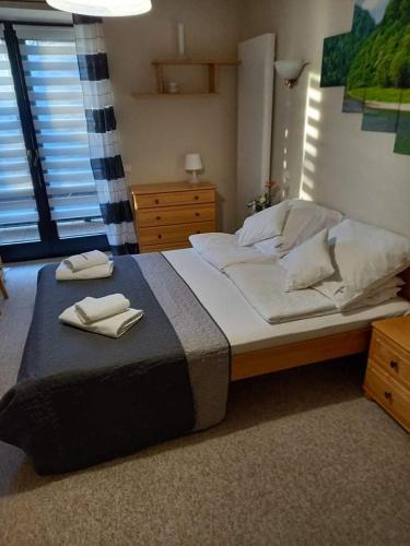 a bedroom with a large bed with two towels on it at Villa Falsztyn Holiday Home in Falsztyn