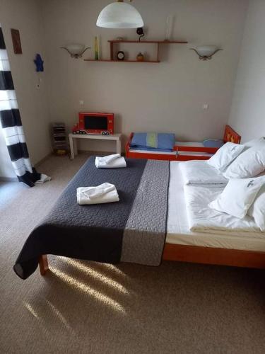 a bedroom with two beds with towels on it at Villa Falsztyn Holiday Home in Falsztyn