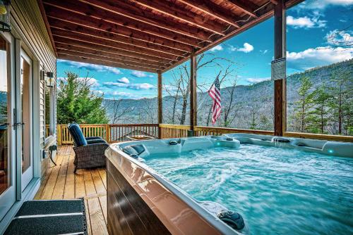a hot tub on a deck with a view of the mountains at Mtn Views - Sauna - Hot Tub - Health - Wellness in Massanutten