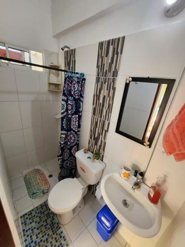 a bathroom with a toilet and a sink at Rancho Ayala in Santa Marta