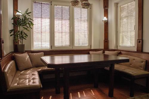 a living room with a couch and a table at Črni Baron Pension Black Baron in Maribor
